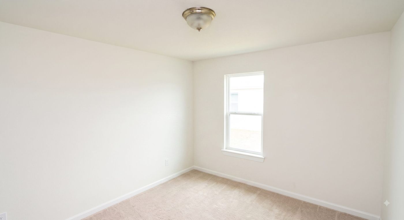 Empty bedroom ceiling with a dated brass and frosted-glass flush-mount light fixture